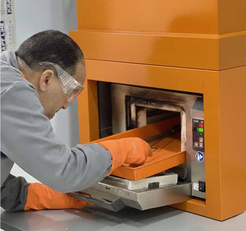 Quality control technician at furnace machine